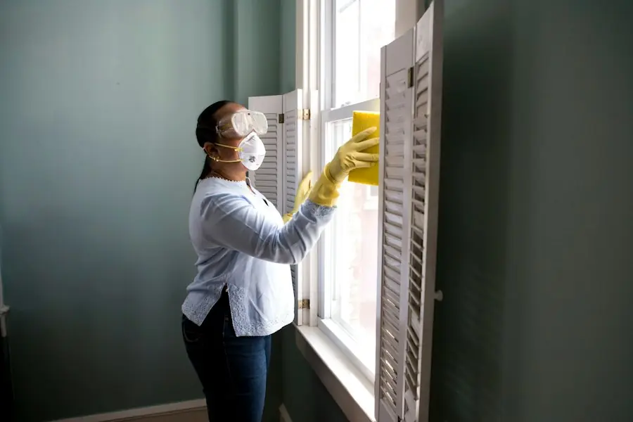 Home service professional cleaning a window